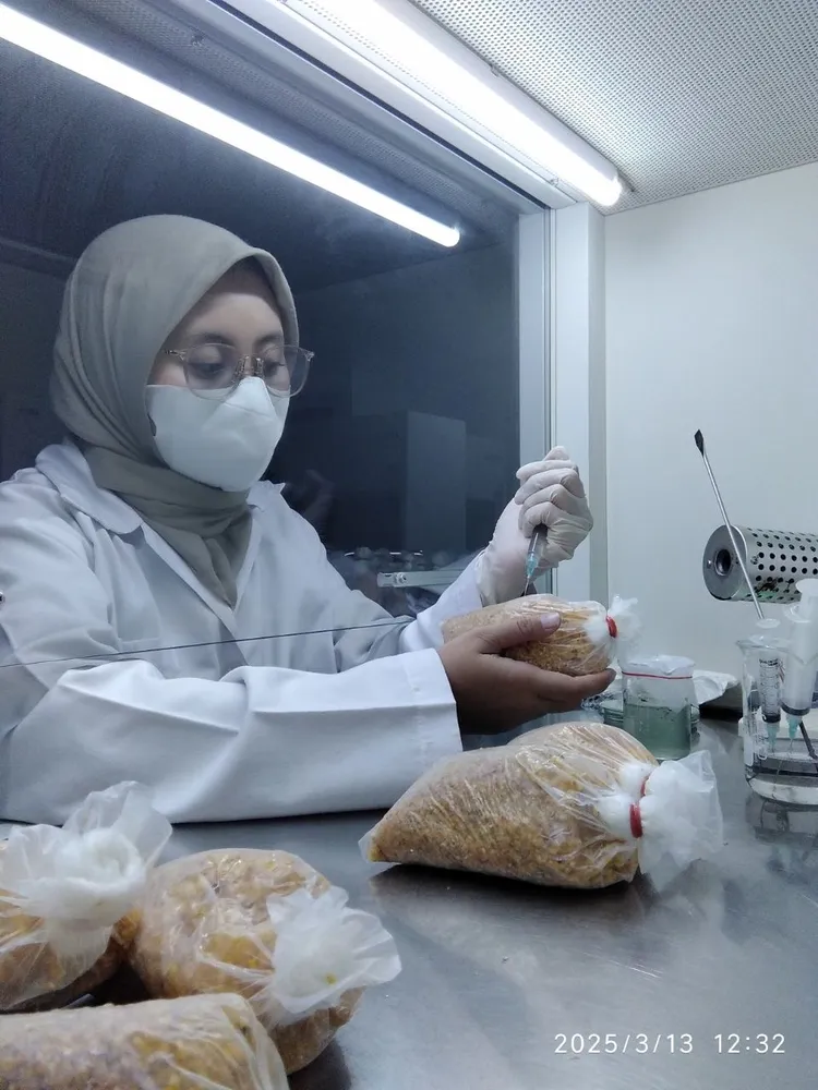 A soil laboratory specialist preparing locally produced biological inputs